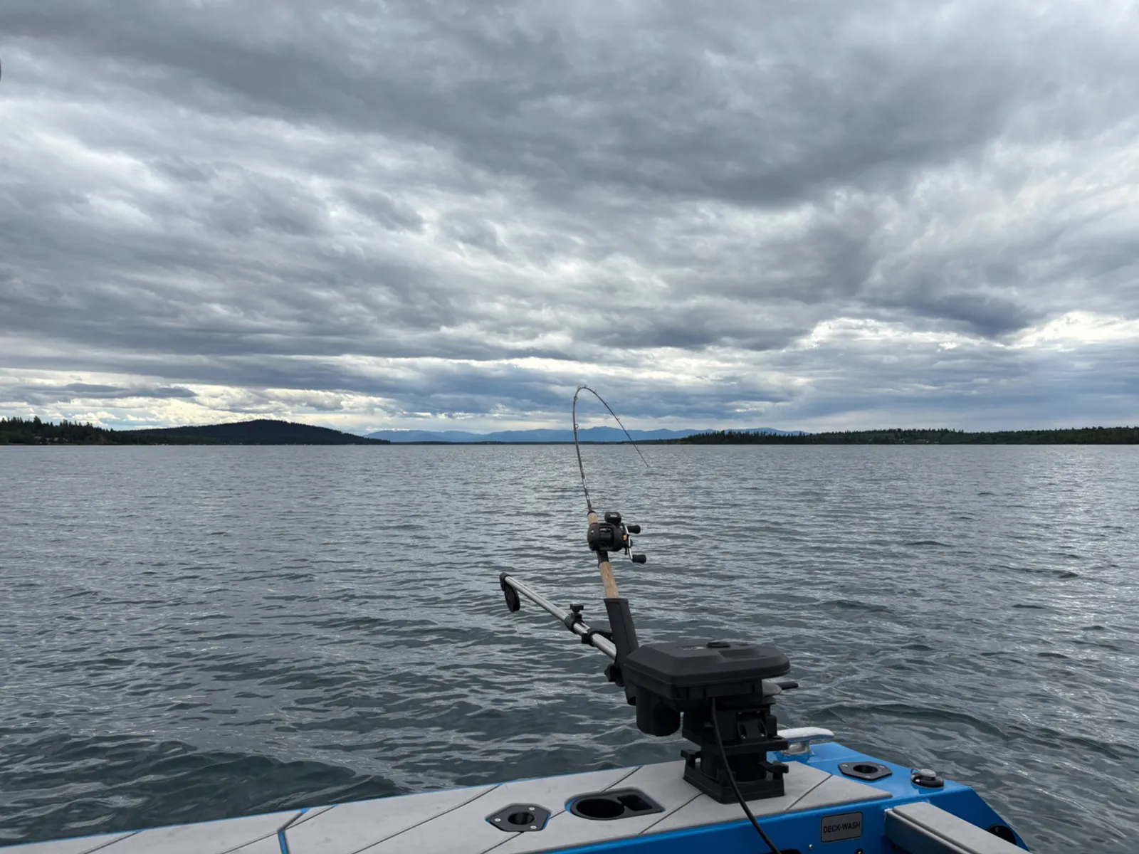 Fishing rod in a boat on Green Lake beneath cloudy skies