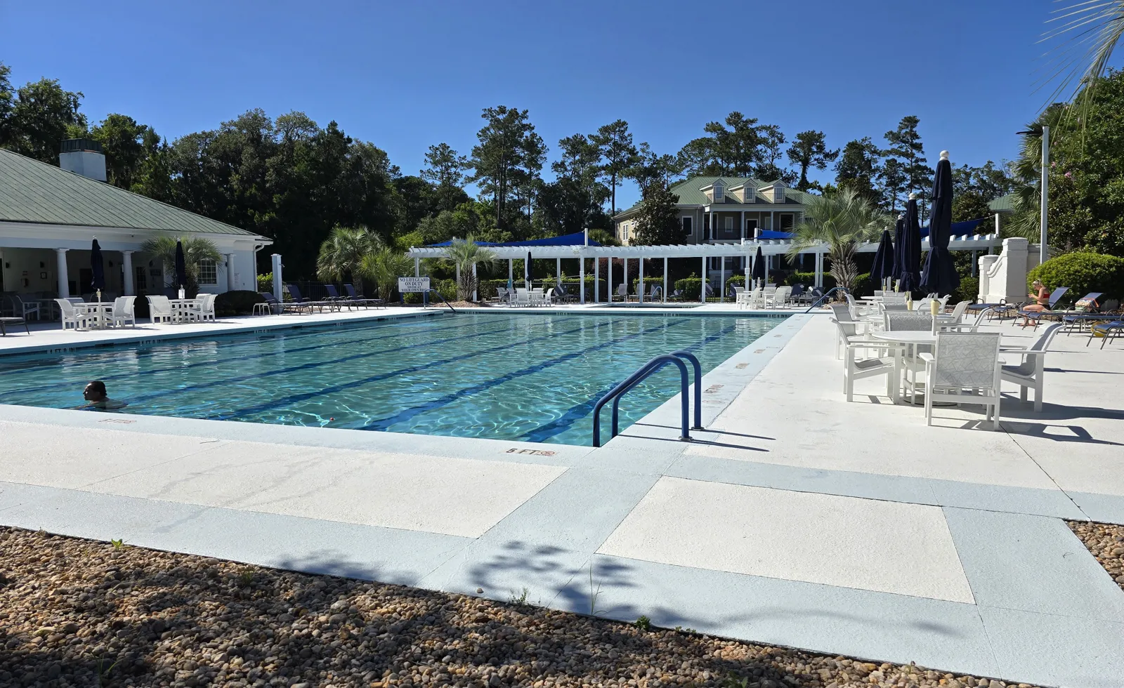 The Crescent community swimming pool in Bluffton SC -- lap lanes, poolside lounge chairs, and pergola shading
