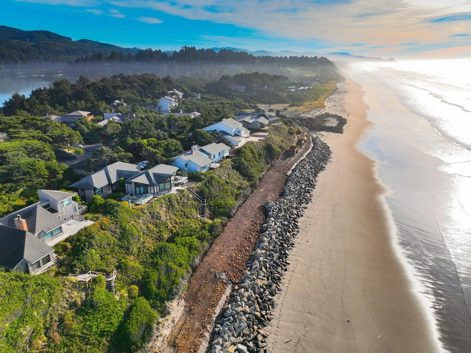 An aerial view of Salishan homes between the forest and the Pacific Ocean
