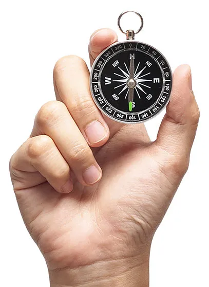 hand holding compass
