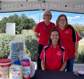 Robin Bragg, Wendi Trevino, and Tori Johnson outside of the Robert J Fischer Team shred event at The Fellowship in Round Rock