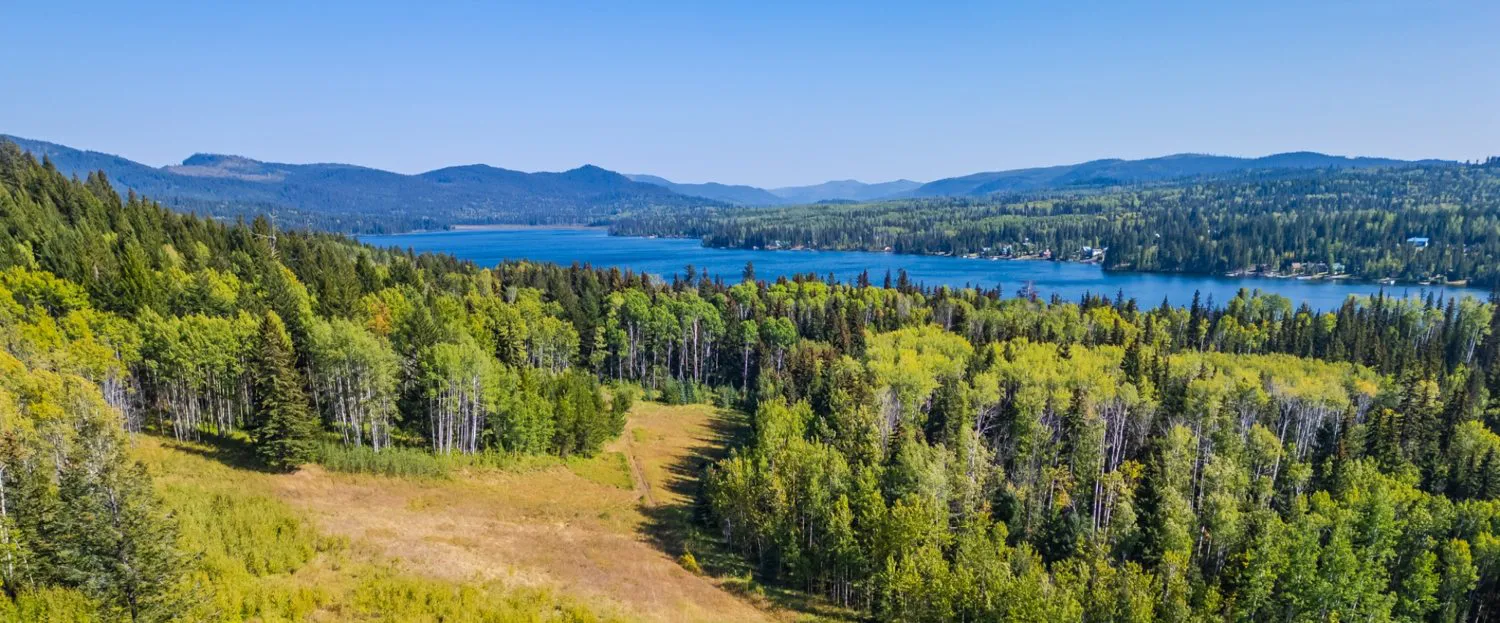 Elevated view over open and wooded land toward a lake in the Deka area
