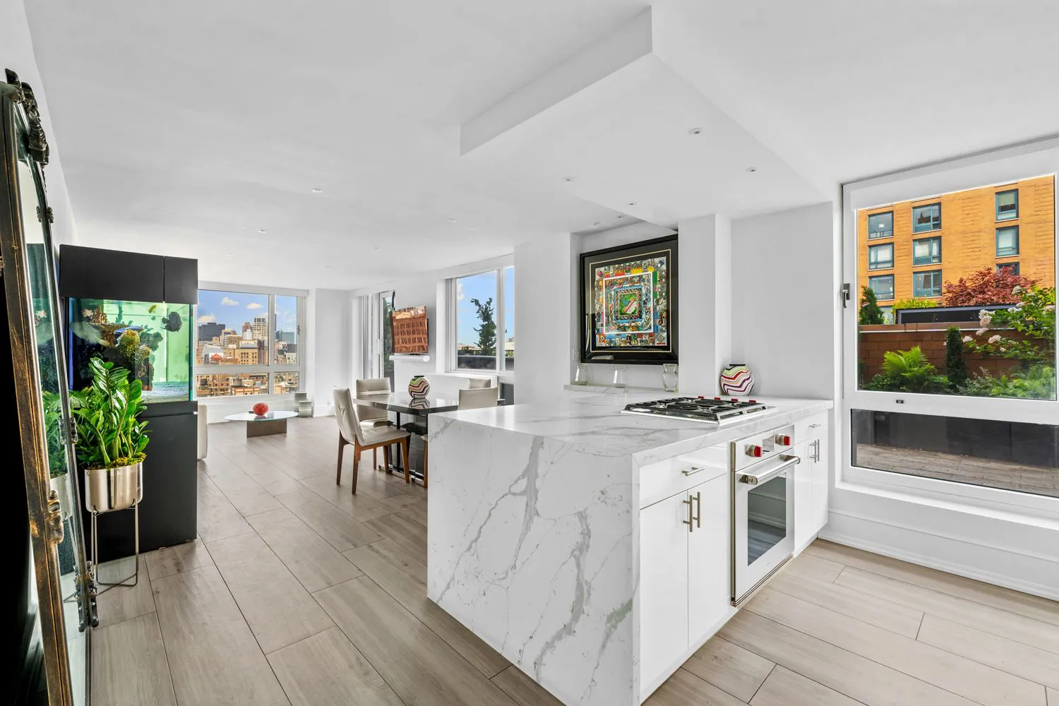 NYC luxury condo with open kitchen, marble island, and skyline views