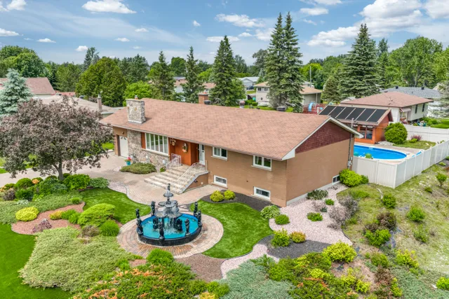 Aerial view of 1638 George Street, its landscaped yard and pool in Val Caron