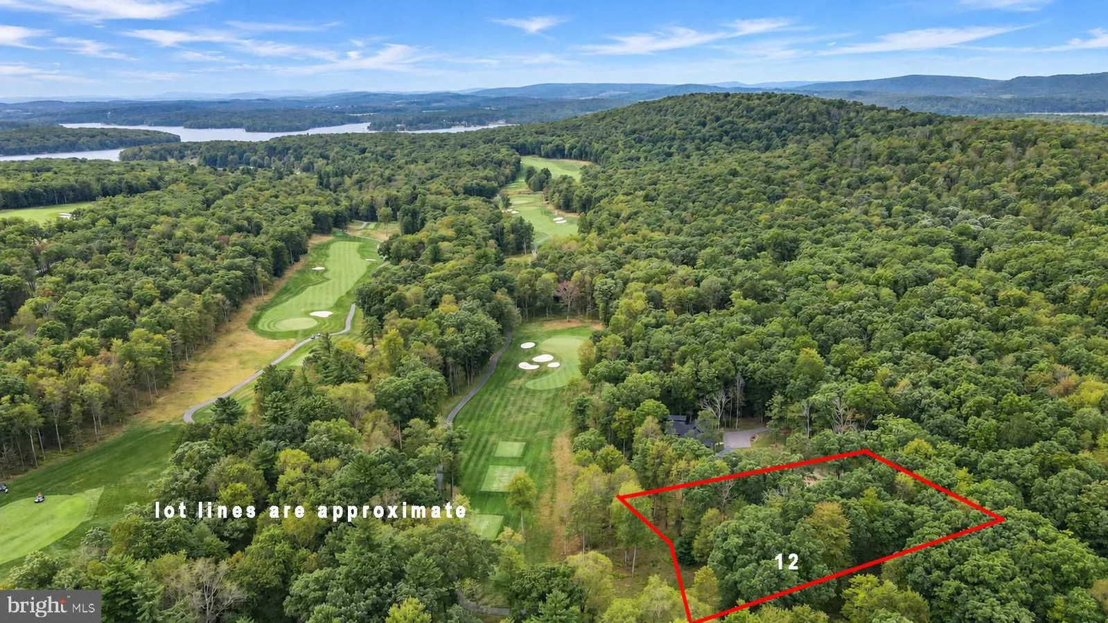 Aerial view of Lot 12 Poland Heights Lane beside the golf course, with Deep Creek Lake in the distance
