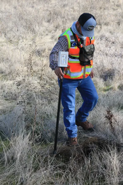 Surveyor surveying vacant land for sale in Colorado
