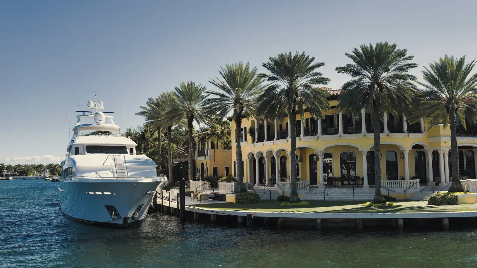 Waterfront home and dock beside a calm blue canal