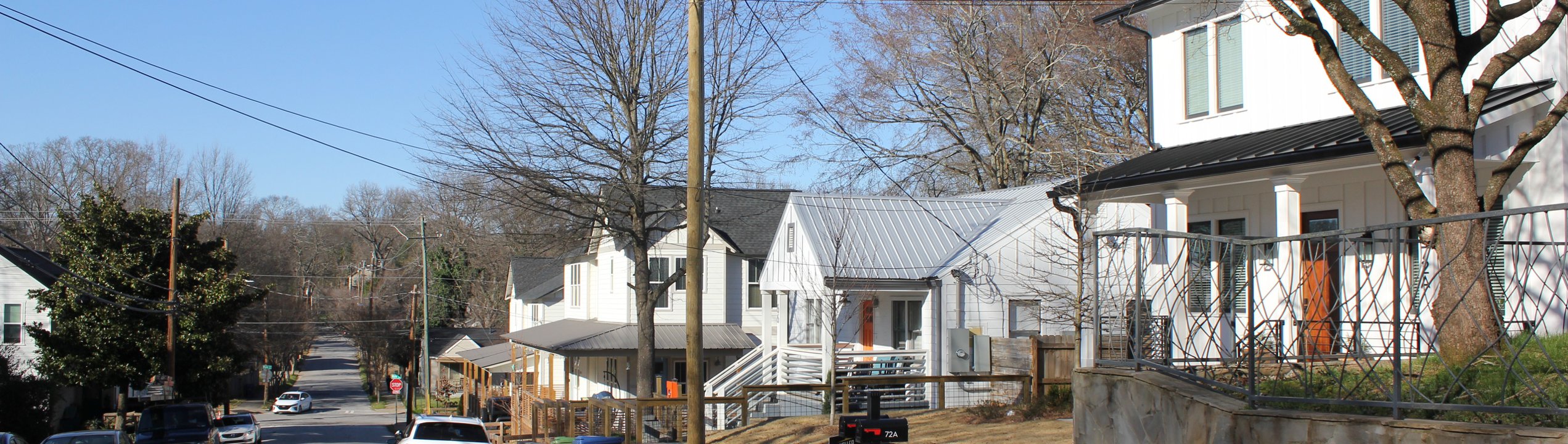 Sunny street scene with a row of Reynoldstown homes