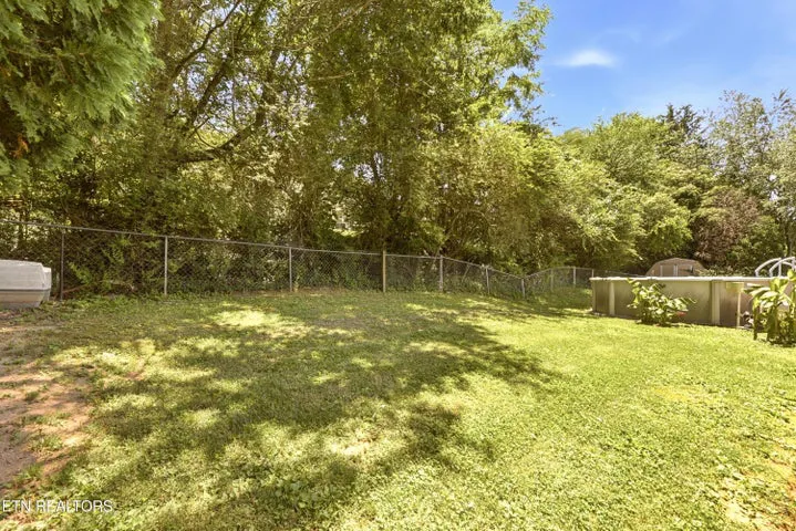 Level backyard with mature trees