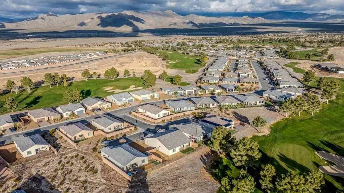 Aerial view of a Pahrump Nevada golf course community with homes, desert open space, and mountain views