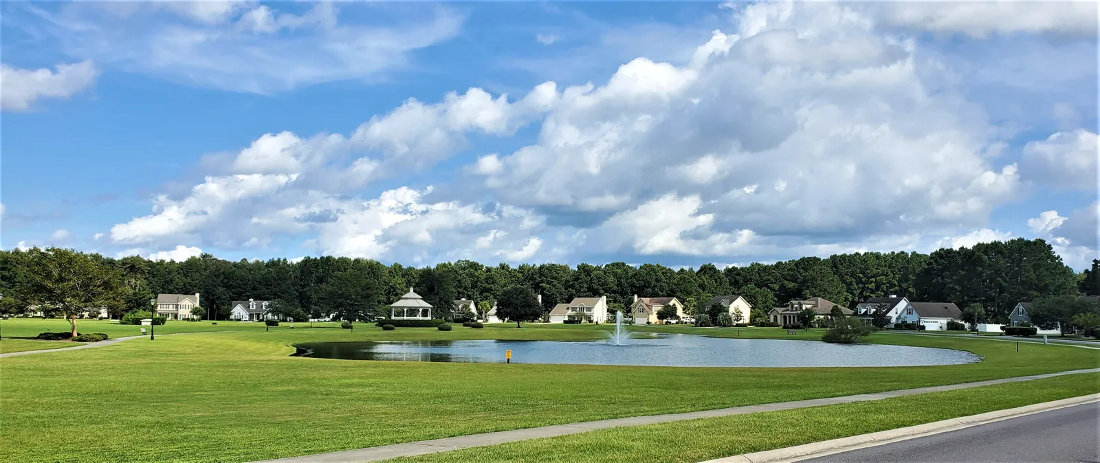 Woodbridge's 13-acre community park in Bluffton, SC, with open lawn under mature oak trees