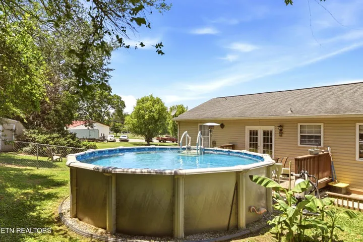 Above-ground pool in the fenced backyard